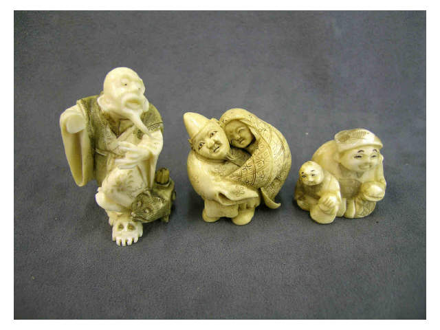 Appraisal: Three ivory netsuke depicting priest with a badger teakettle damaged