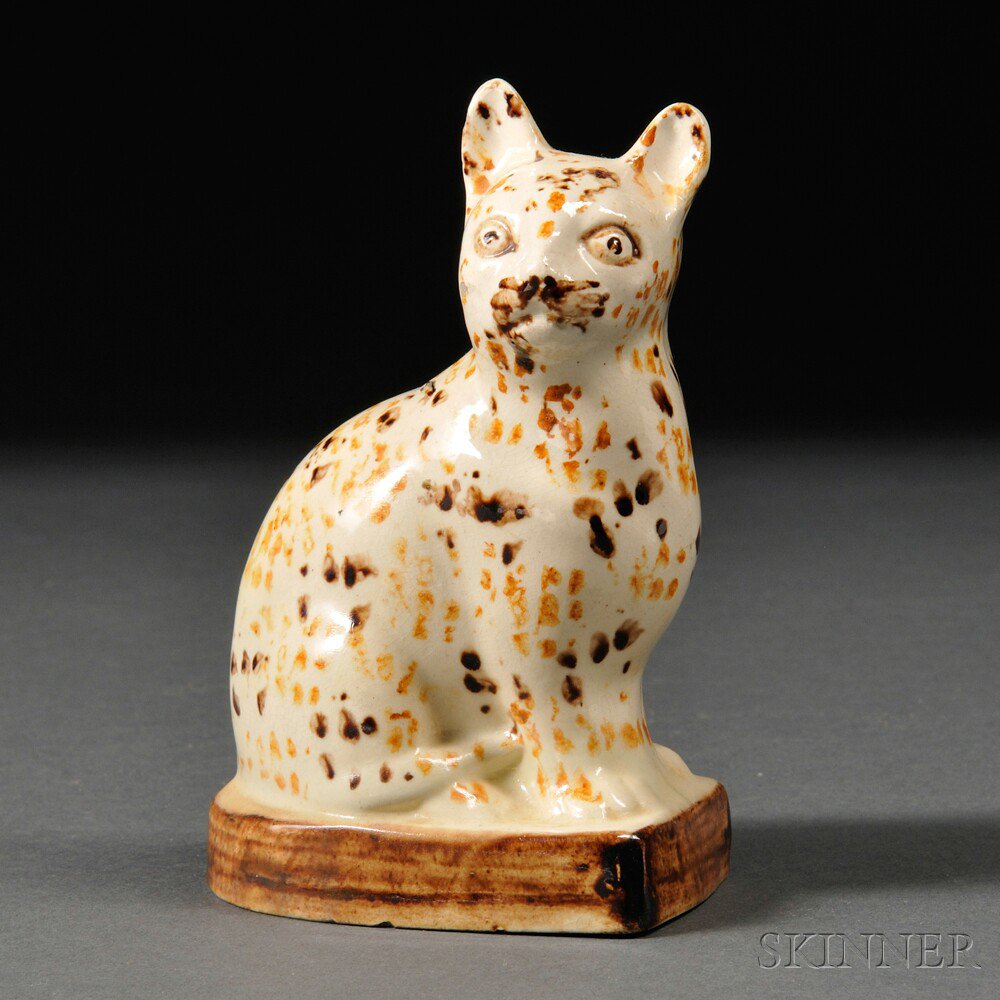 Appraisal: Staffordshire Cream-colored Earthenware Model of a Speckled Cat England c