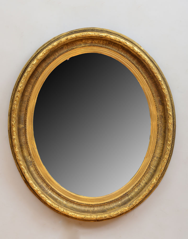 Appraisal: LATE REGENCY GILTWOOD OVAL MIRROR The oval mirror plate within