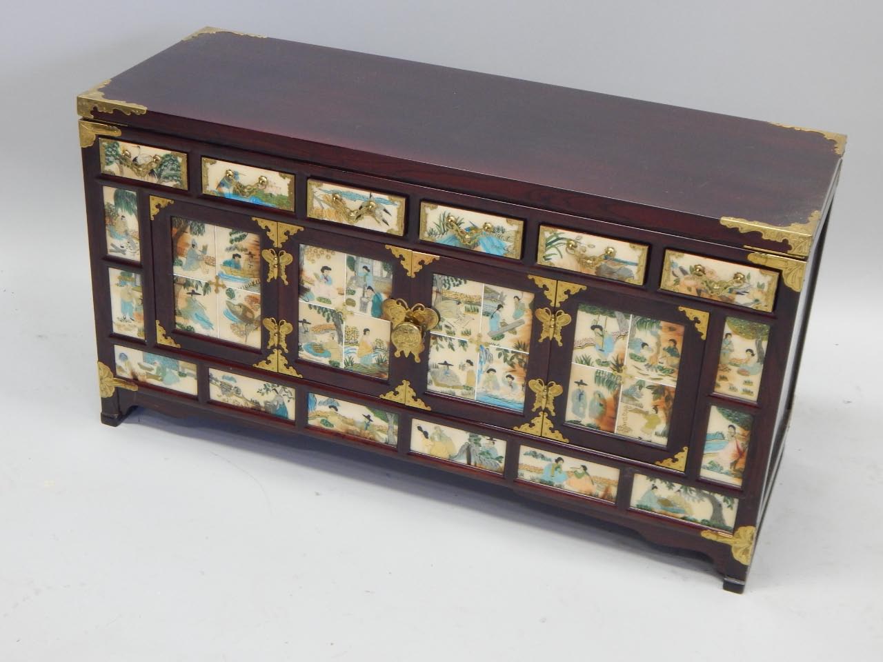 Appraisal: A thC Oriental low cabinet with brass corners the various