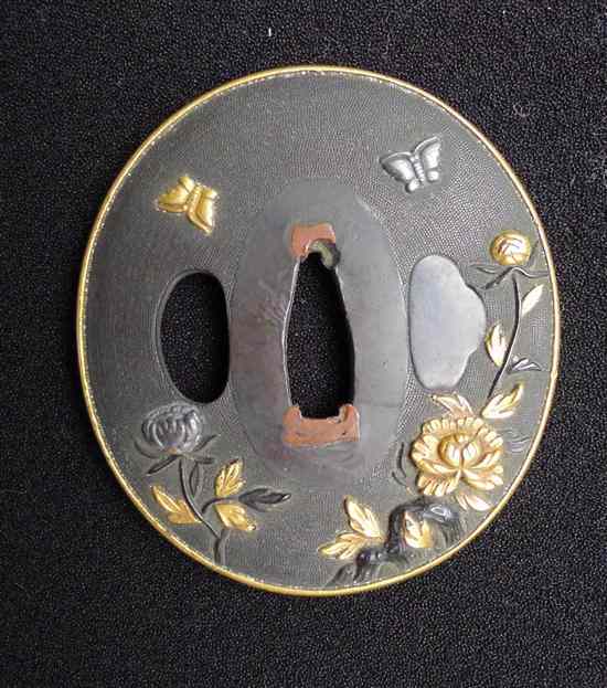 Appraisal: A Meiji period gold silver and copper overlaid bronze tsuba