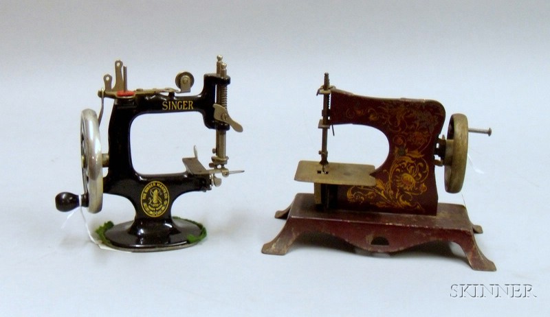 Appraisal: Two Toy Sewing Machines early th century Singer black cast