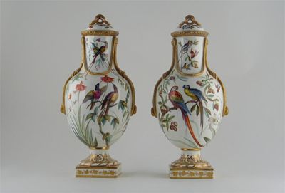 Appraisal: A pair of Coalport ovoid vases and covers painted by