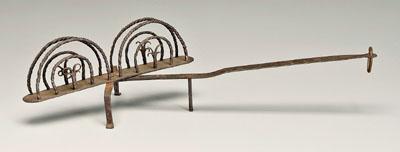 Appraisal: Wrought iron toaster T-shaped frame with tripod feet conforming spiraled