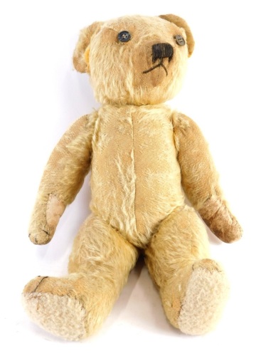 Appraisal: A thC blonde plush jointed teddy bear with button eyes