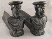 Appraisal: A pair of cast iron firedogs with the bust of