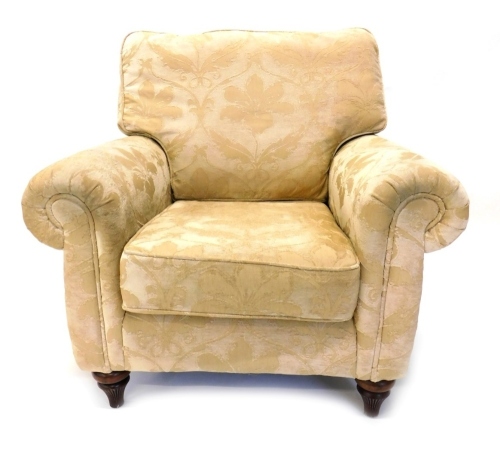 Appraisal: An armchair upholstered in gold damask type fabric on turned