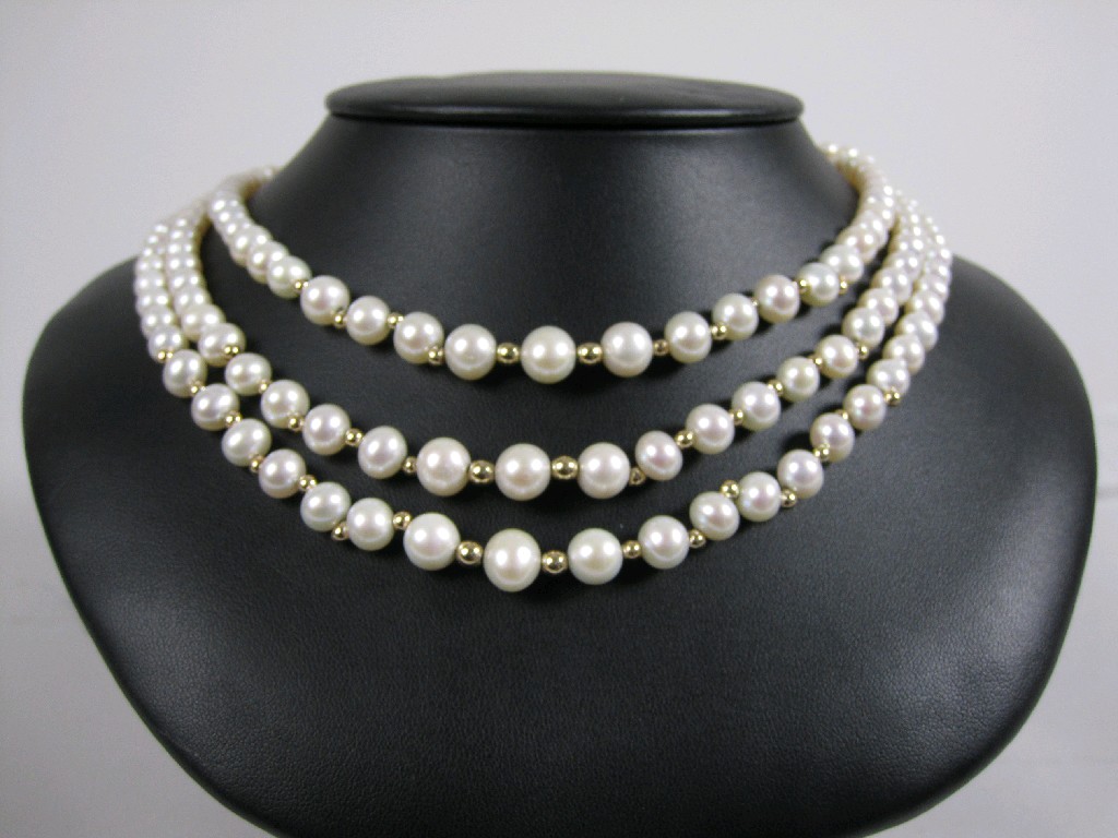 Appraisal: A triple row graduated Cultured Pearl Necklace with gold bead