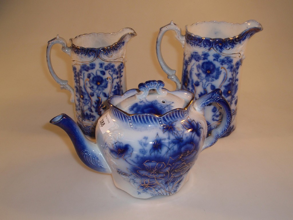 Appraisal: Two Victorian Staffordshire flow blue relief moulded graduated jugs and