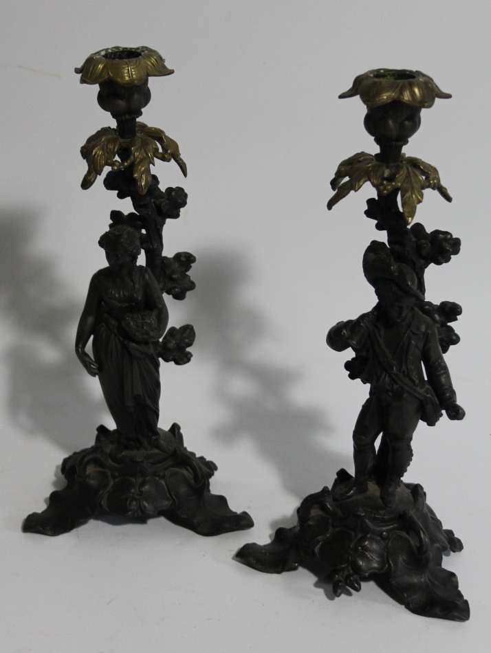 Appraisal: A pair of thC cast two colour metal figural candlesticks