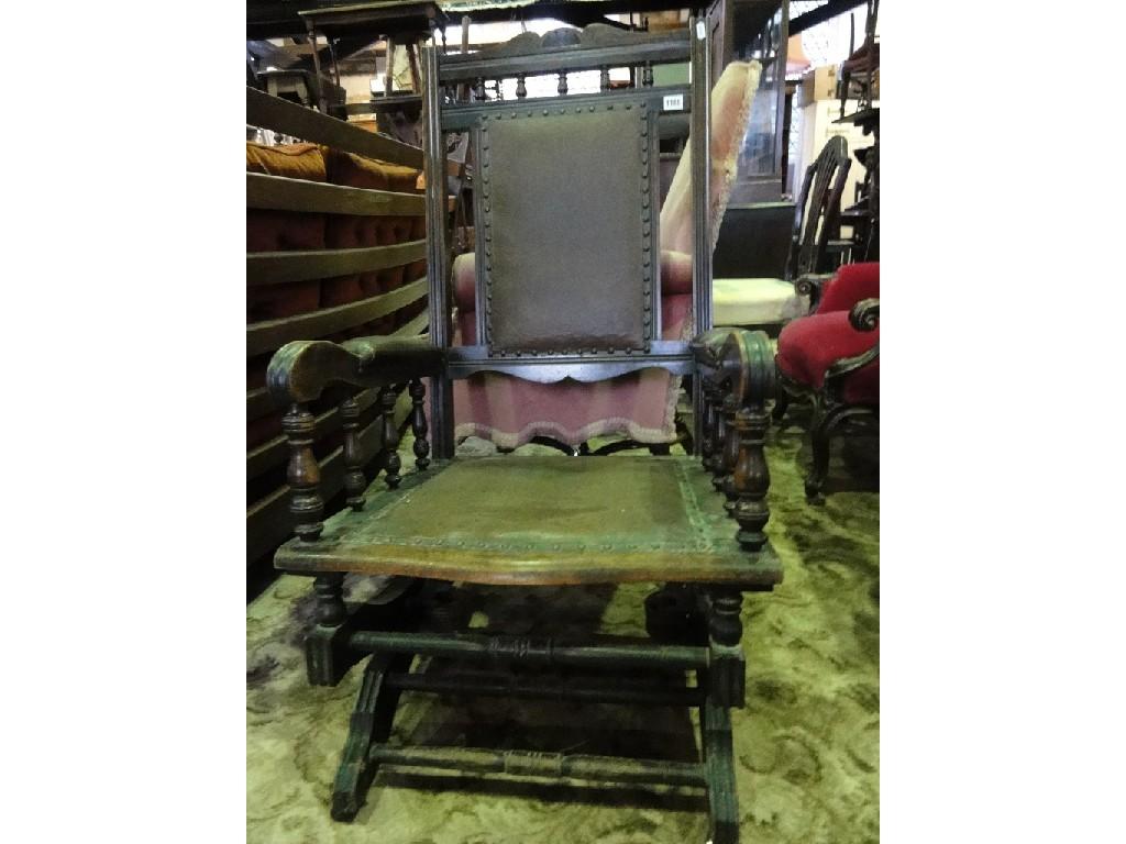 Appraisal: An Edwardian American rocking chair with leatherette upholstered pad seat