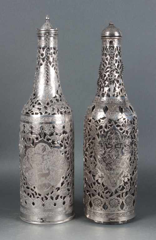 Appraisal: Pair of Persian reticulated and engraved wine bottle covers with