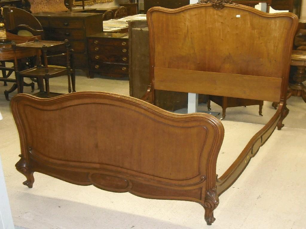 Appraisal: th century French mahogany double bed with a rococo foliate