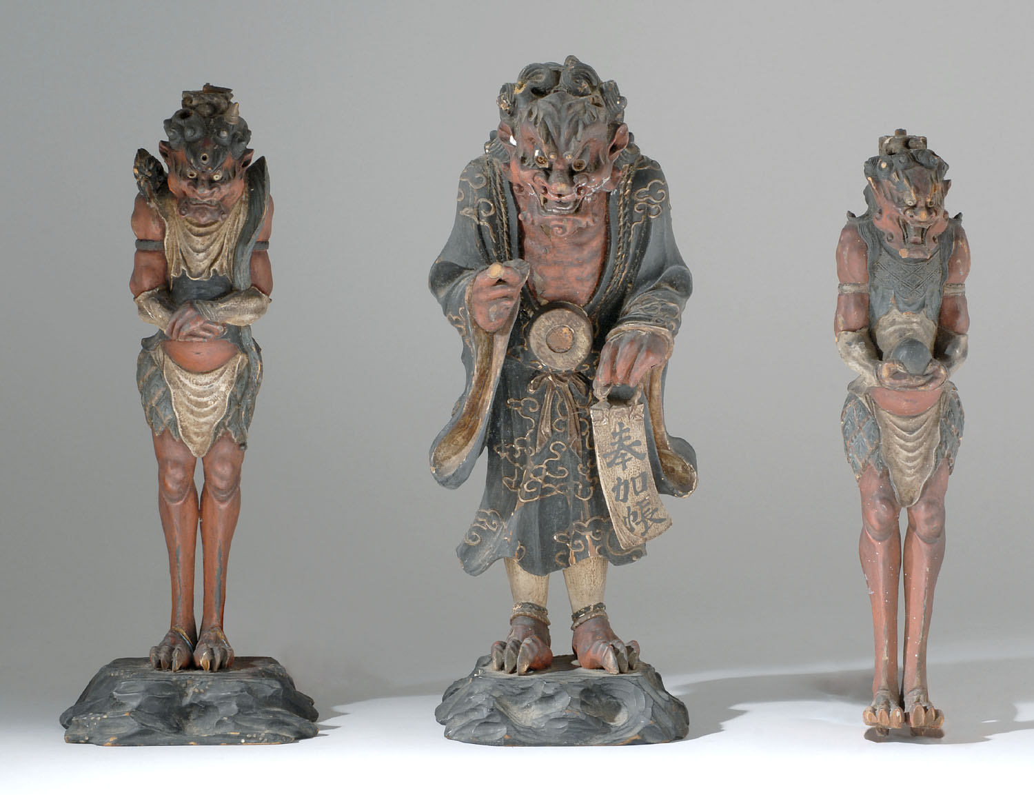 Appraisal: SET OF THREE POLYCHROME CARVED WOOD DEMON FIGURES Edo PeriodCentral