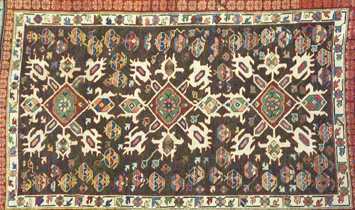 Appraisal: Caucasian rug with triple geometric medallions on a black brown