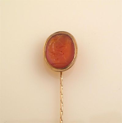 Appraisal: A gold stick pin mounted with a carnelian intaglio depicting