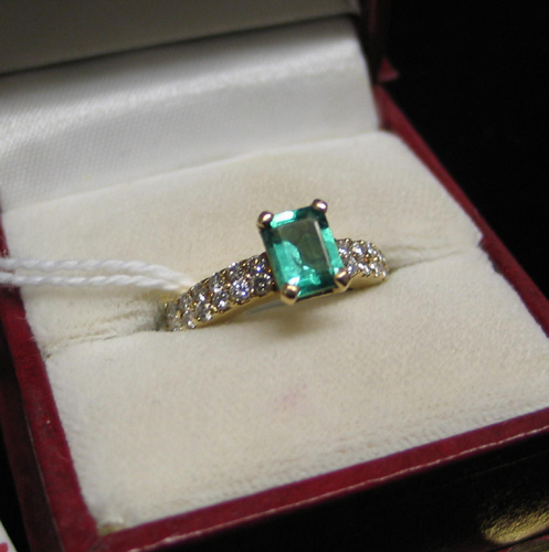 Appraisal: EMERALD DIAMOND AND FOURTEEN KARAT GOLD RING centering an emerald-cut