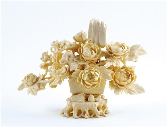 Appraisal: Chinese carved ivory figurine circa blooming peony branches within vase