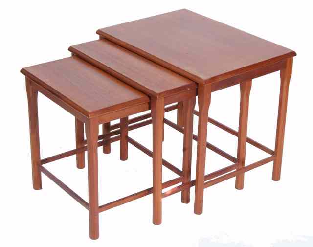 Appraisal: A NEST OF THREE TEAK OCCASIONAL TABLES with chamfered legs