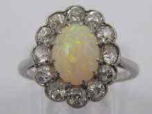 Appraisal: An opal and diamond ring set in platinum the opal