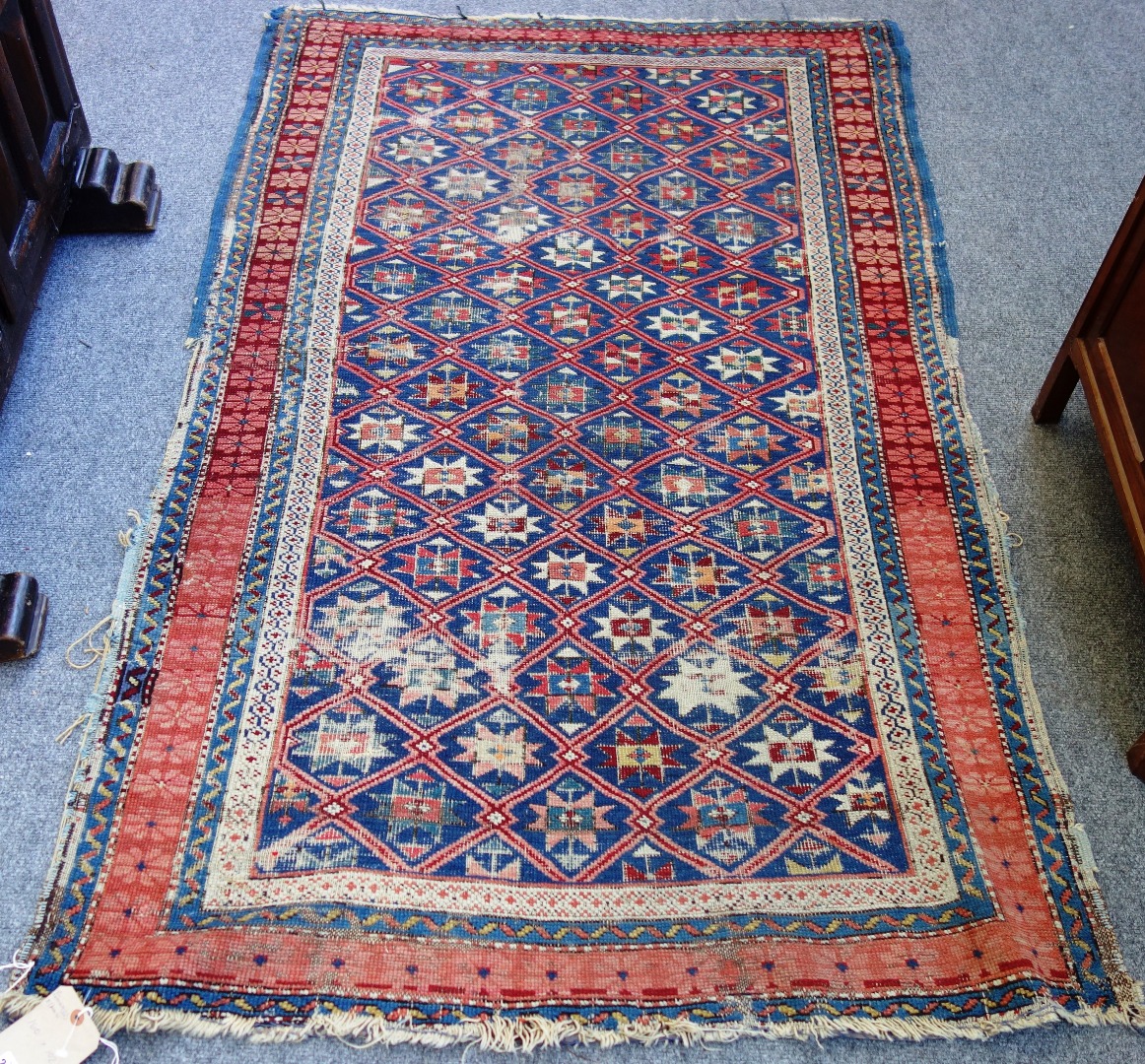 Appraisal: A Seychour rug Caucasian the indigo trellis field with single