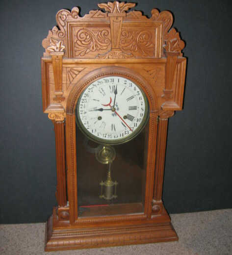 Appraisal: WATERBURY CALENDER SHELF CLOCK In a carved walnut case having