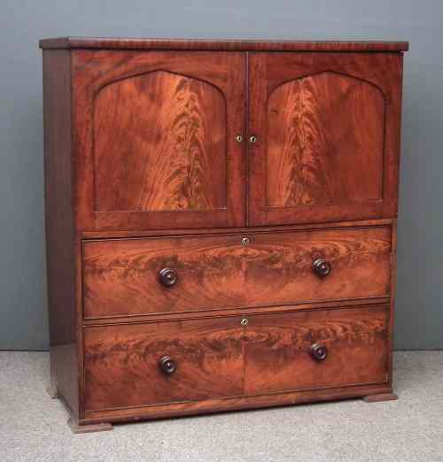 Appraisal: An early Victorian figured mahogany millinery cabinet enclosed by a