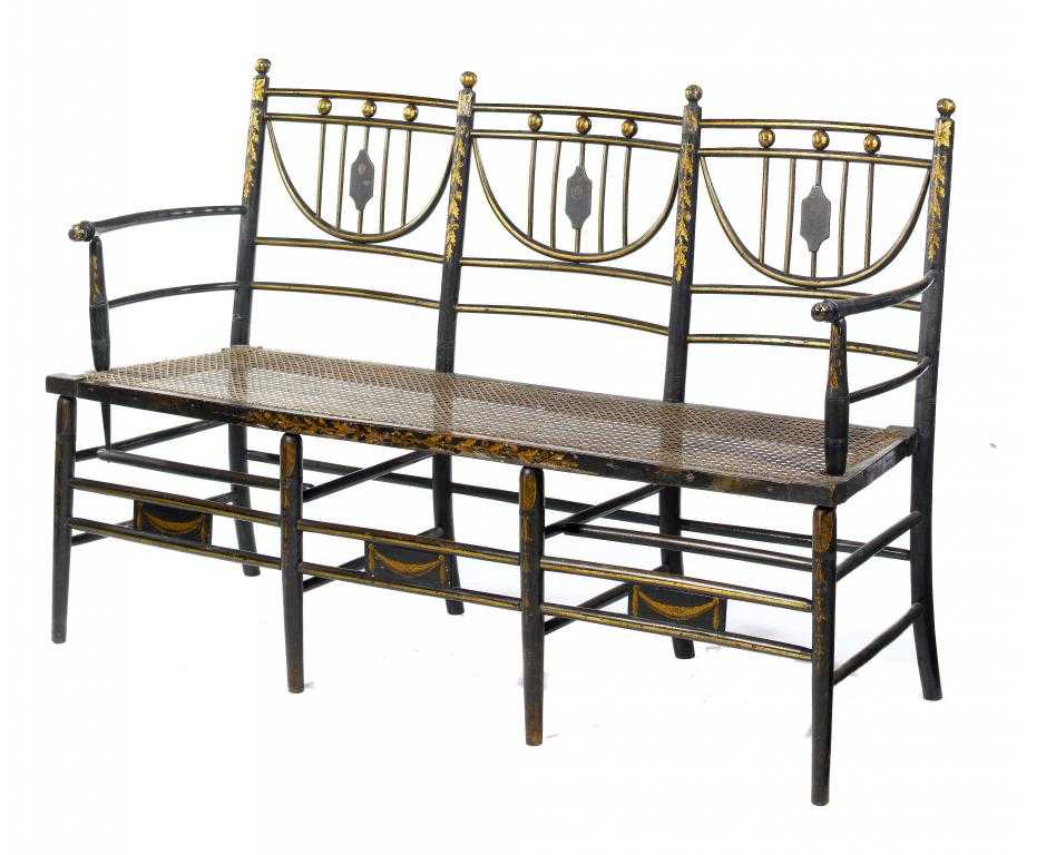 Appraisal: A REGENCY EBONISED AND GILT TRIPLE CHAIR-BACK SETTEE with floral