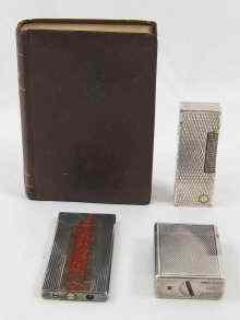 Appraisal: A Dunhill table lighter designed as a book titled ''The