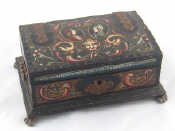 Appraisal: A hardwood jewel box with strap hinges paw feet and