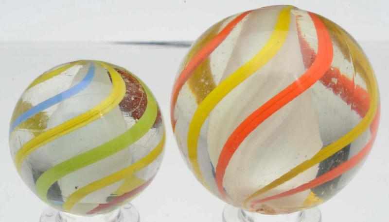 Appraisal: Lot of Solid Core English Swirl Marbles The smaller marble