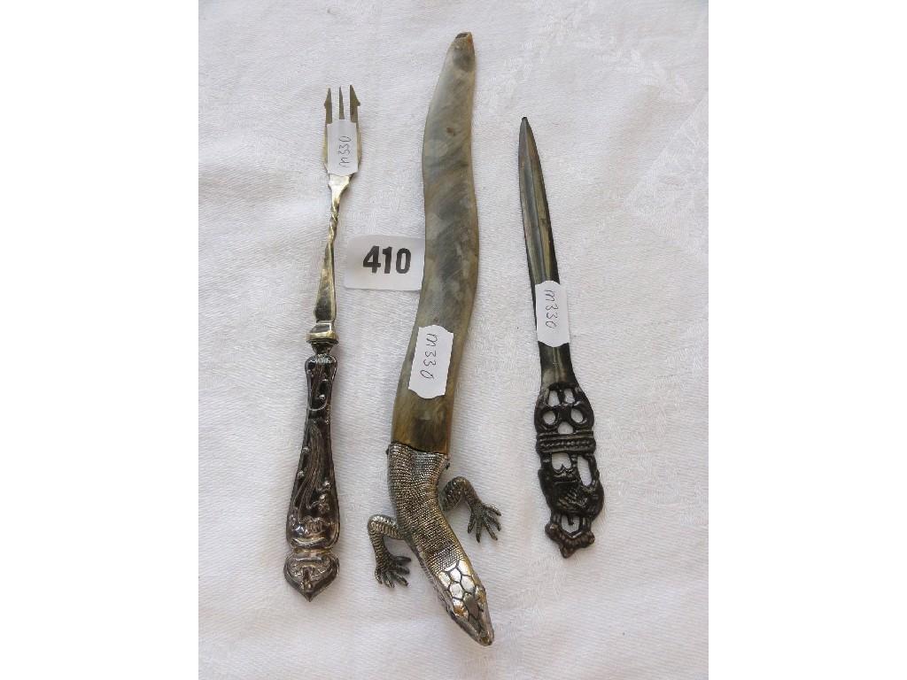 Appraisal: A horn letter knife with silver metal handle in the