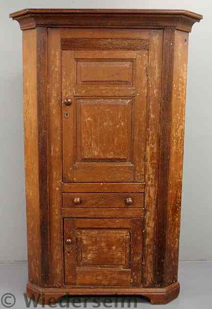 Appraisal: Pine one-piece corner cupboard early th c with a molded