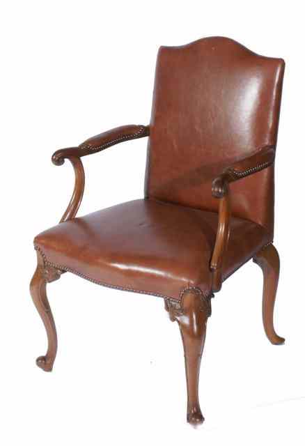 Appraisal: A GEORGE II STYLE WALNUT FRAMED OPEN ARMCHAIR with leather