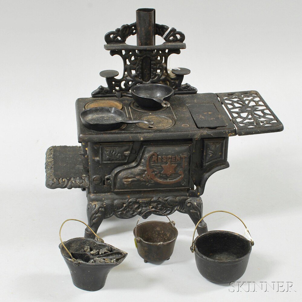 Appraisal: Miniature Crescent Cast Iron Toy Stove with four pots and