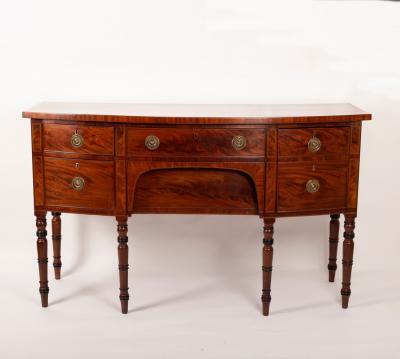 Appraisal: A George III mahogany bowfront sideboard on turned tapering legs