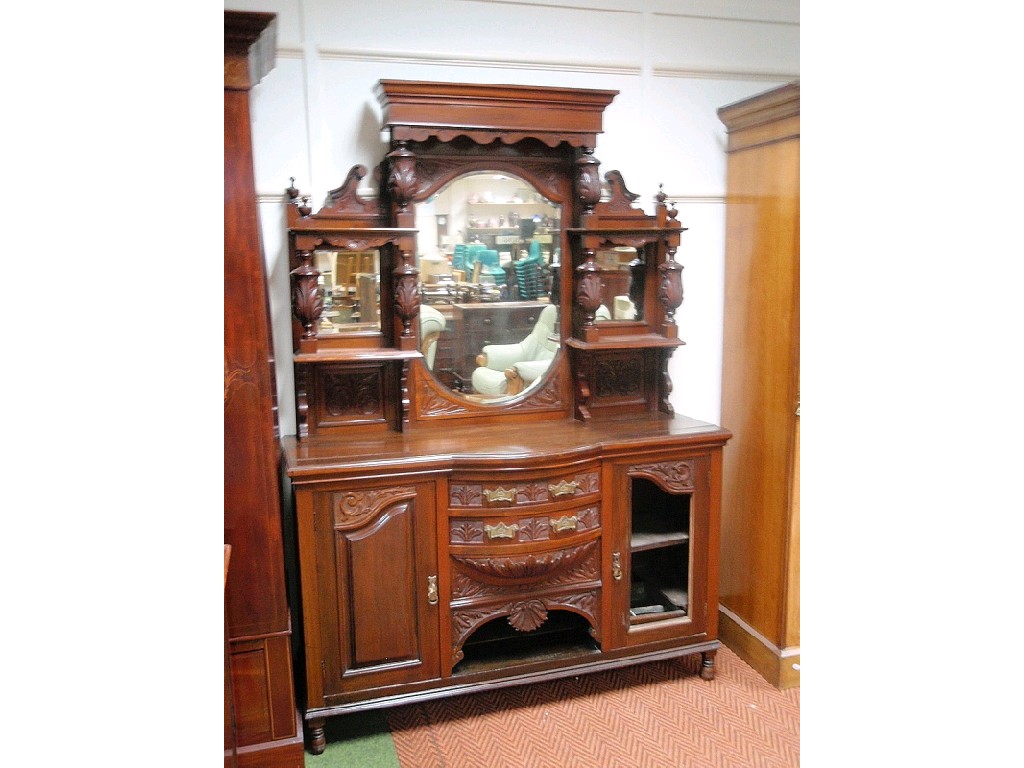 Appraisal: A late Victorian carved walnut dresser with mirrored and shelf