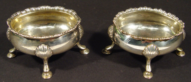 Appraisal: Pair of Georgian silver four footed salts with shell cast