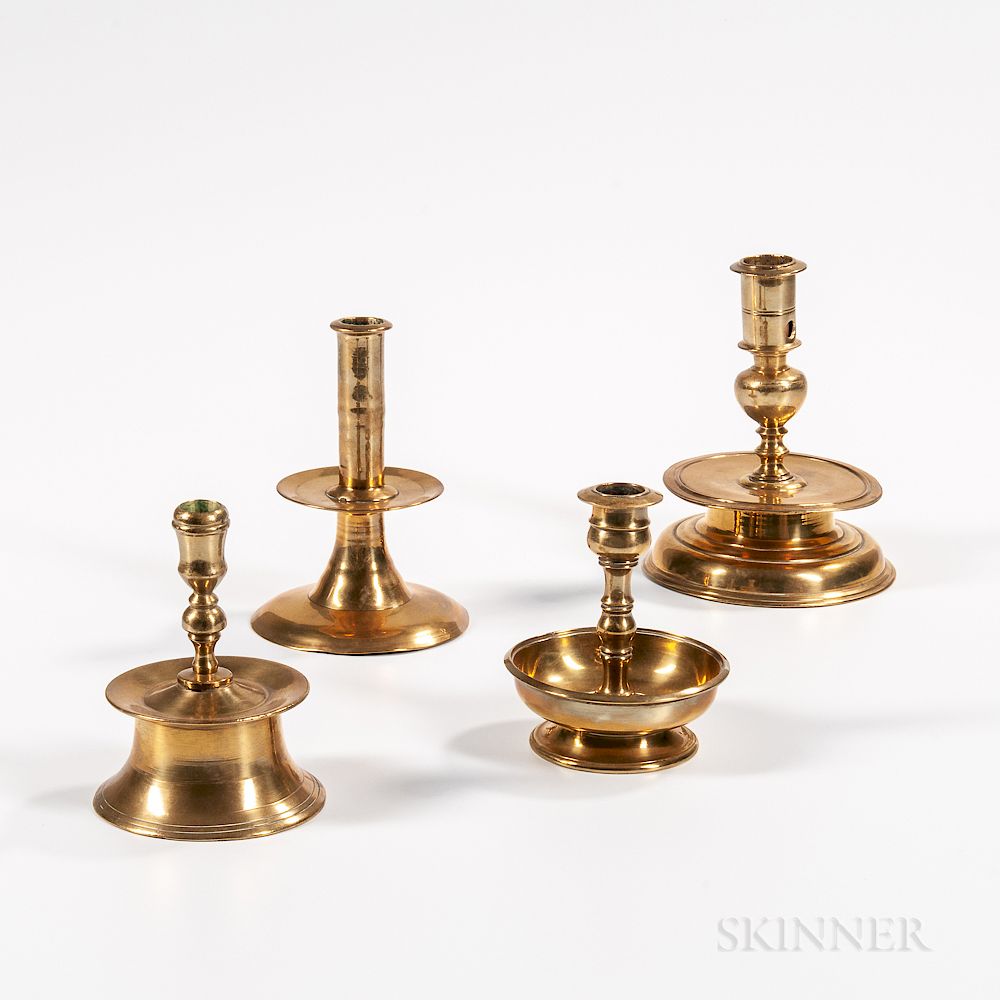 Appraisal: Four Early Brass Candlesticks Four Early Brass Candlesticks England and