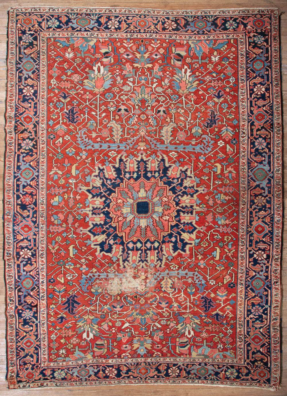 Appraisal: Antique Heriz Carpet red orange ground blue border central medallion