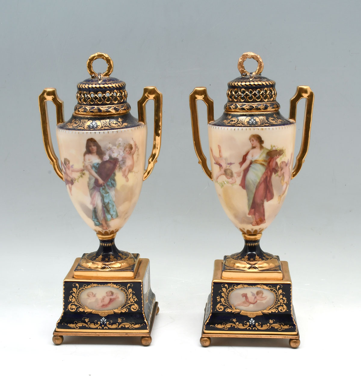 Appraisal: ROYAL VIENNA FIGURAL LIDDED URNS - Double handled urns having