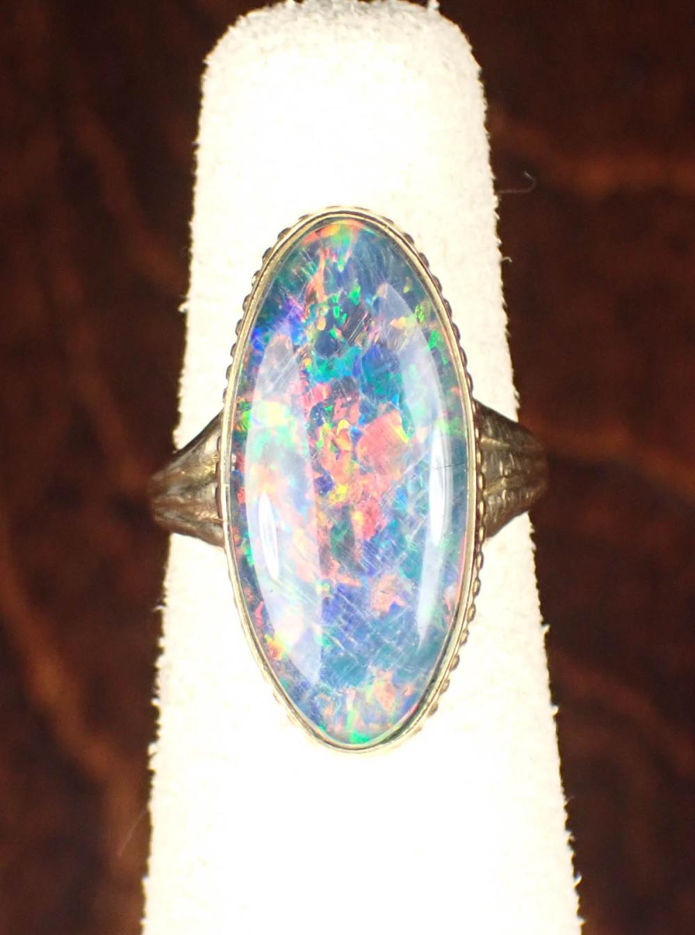 Appraisal: BLACK OPAL TRIPLET AND FOURTEEN KARAT GOLD RING The yellow