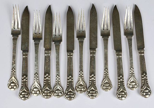 Appraisal: A SET OF TWELVE DANISH KNIVES AND FORKS with beaten