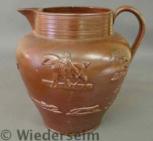 Appraisal: Oversize English pottery pitcher c decorated with relief human and