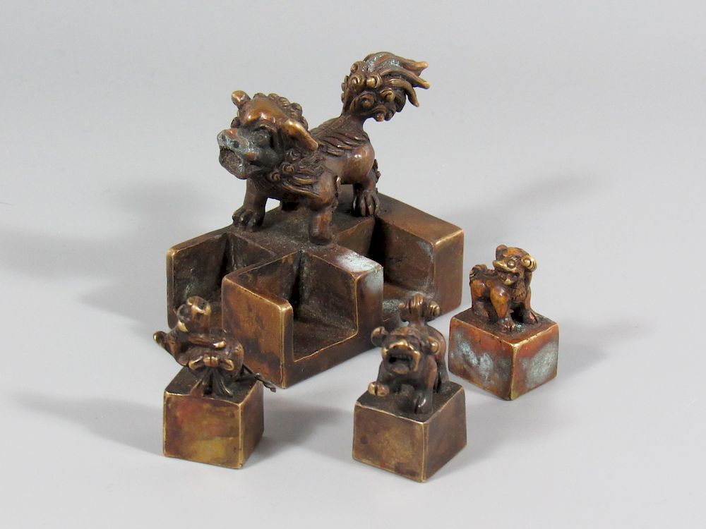 Appraisal: Bronze Lion and Cubs Nesting Seal A fierce mother lion