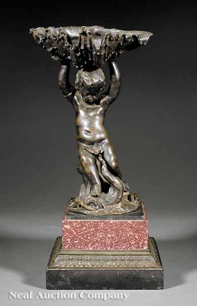 Appraisal: An Italian Bronze Figural Salt Cellar of a Putto Holding