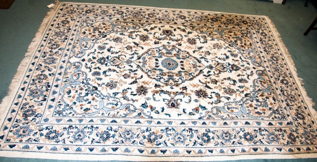 Appraisal: Cream field with blue floral decorations