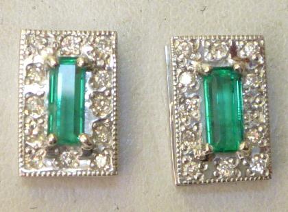 Appraisal: A PAIR OF EMERALD AND DIAMOND STUD EARRINGS the central