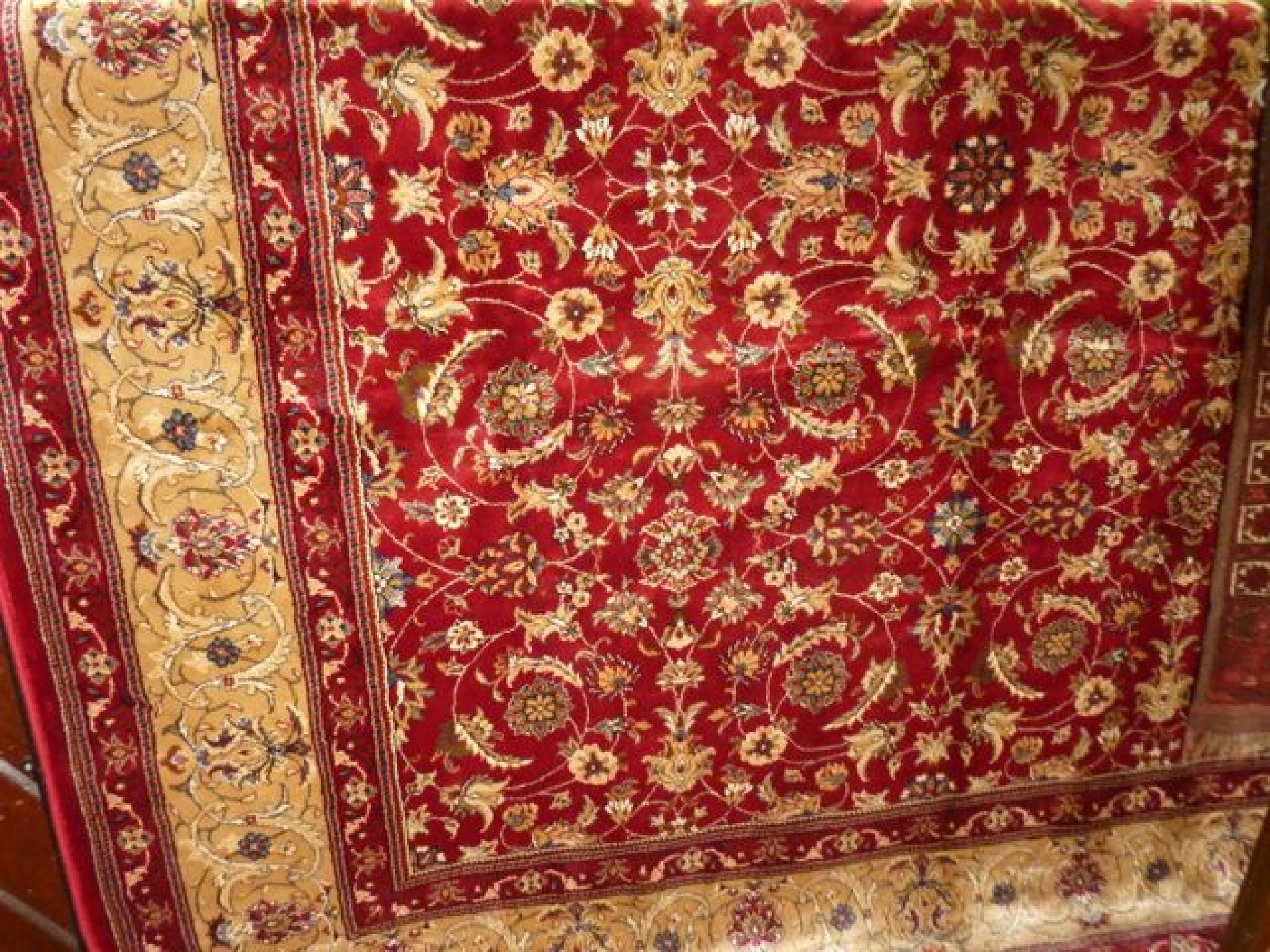 Appraisal: A Persian style red ground carpet with abstract trailing floral