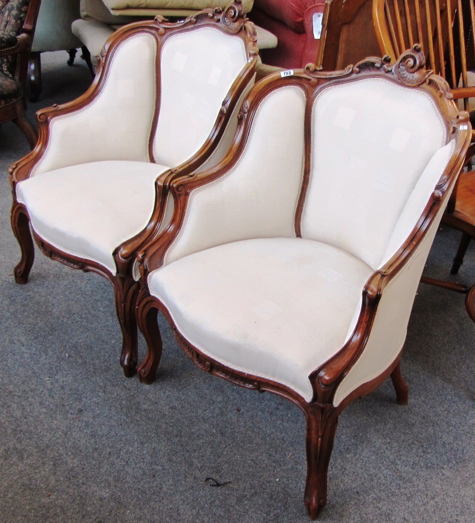 Appraisal: A pair of Victorian style walnut framed tub back chairs